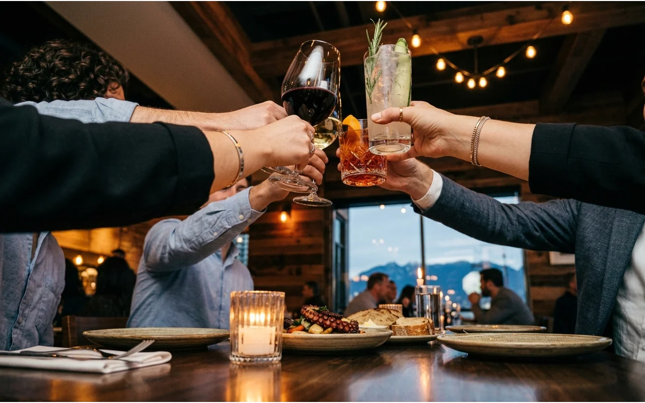 A team sharing dinner around a long restaurant table